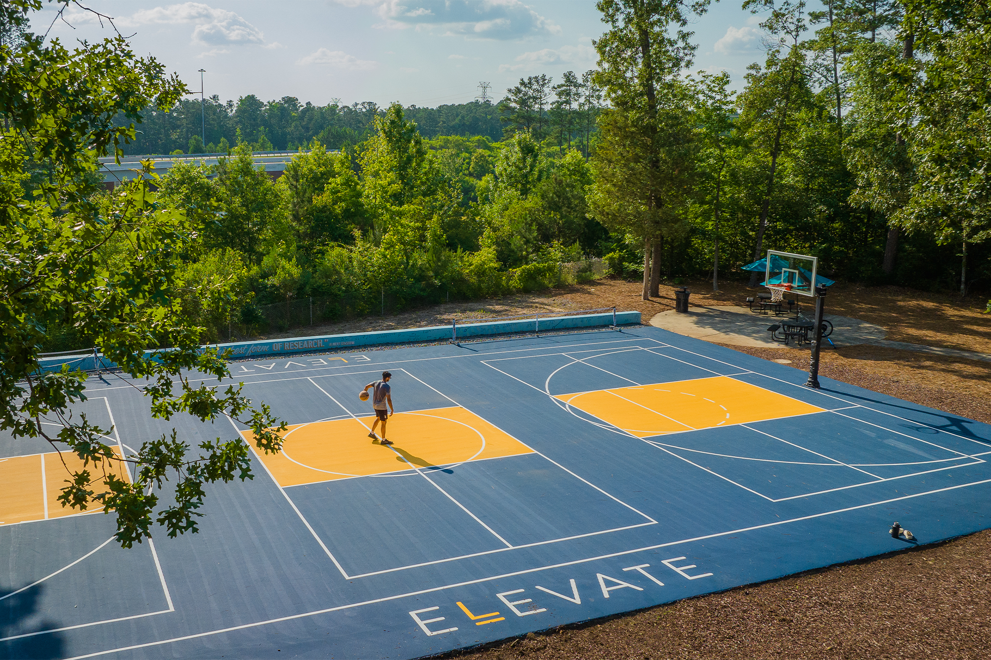 Person playing basketball on Elevate court outside